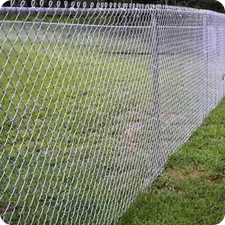 A galvanized steel chain-link fence enclosing a grassy area.