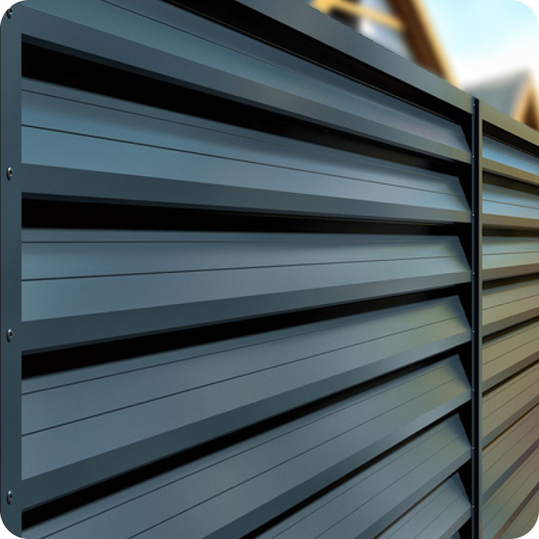 Close-up of a modern dark gray aluminum louvered privacy fence.
